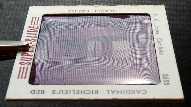 Reflection grid pattern revealing uneven film surface